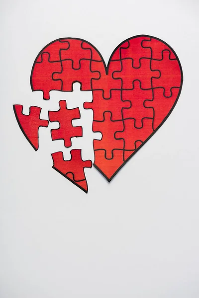 Top view of drawn red heart shape jigsaw isolated on white with copy space — Stock Photo