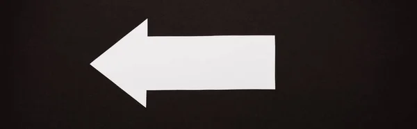 Panoramic shot of directional arrow isolated on black — Stock Photo