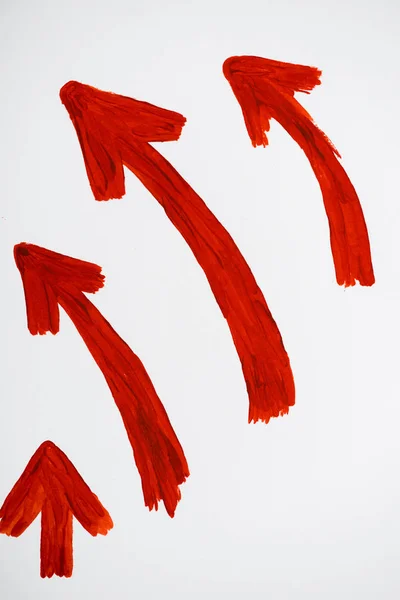 Red and drawn directional arrows showing up and left on white — Stock Photo