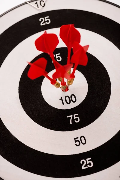 Selective focus of black and white dartboard with red arrows — Stock Photo