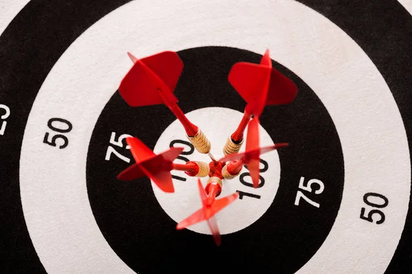 Top view of black and white dartboard with red arrows — Stock Photo