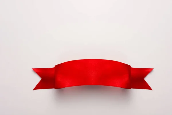 Top view of red and satin ribbon on white — Stock Photo