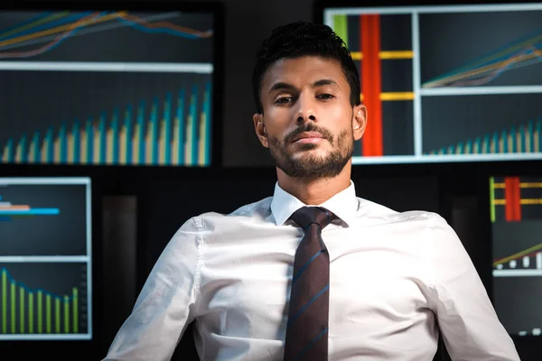 Bi-racial and handsome trader looking at camera in office — Stock Photo