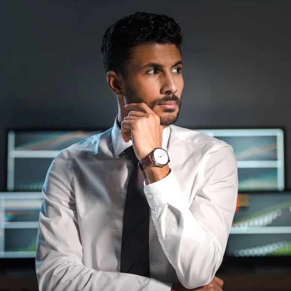 Pensive and handsome bi-racial trader looking away in office — Stock Photo