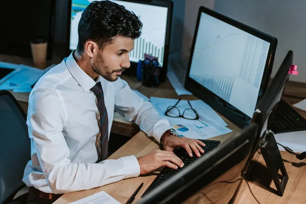 High angle view of bi-racial trader using computer and sitting at table — Stock Photo