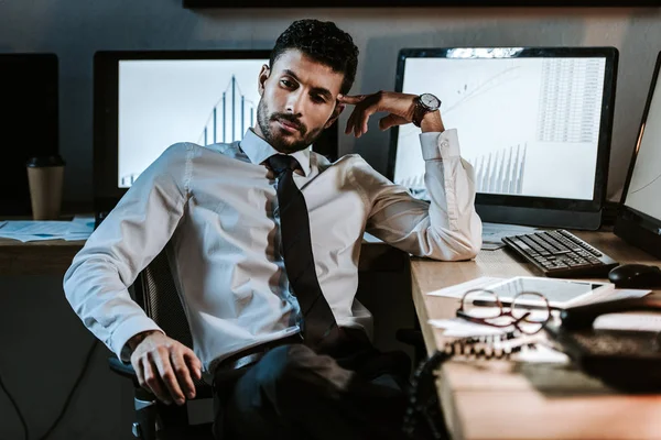 Pensive bi-racial trader sitting at table and looking away — Stock Photo