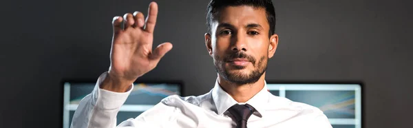 Panoramic shot of bi-racial trader pointing with finger — Stock Photo