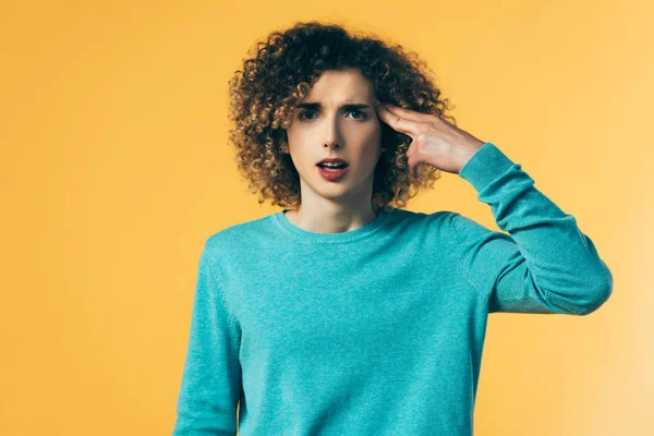 Stressed curly teenager isolated on yellow — Stock Photo