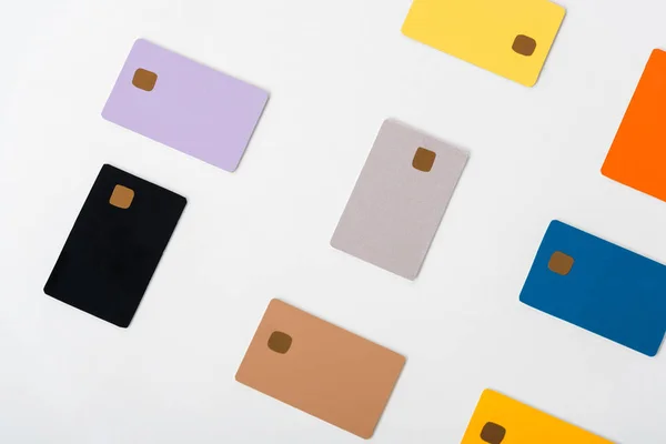 Top view of multicolored credit card templates isolated on white — Stock Photo