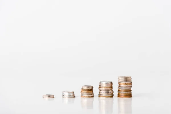 Stacks of silver and golden coins on white — Stock Photo