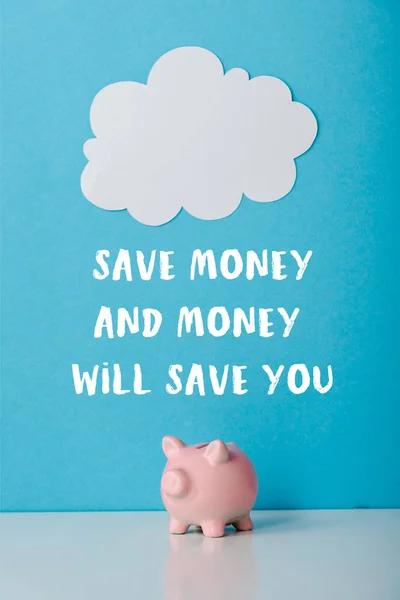 Pink piggy bank near white cloud and save money and money will save you letters on blue — Stock Photo