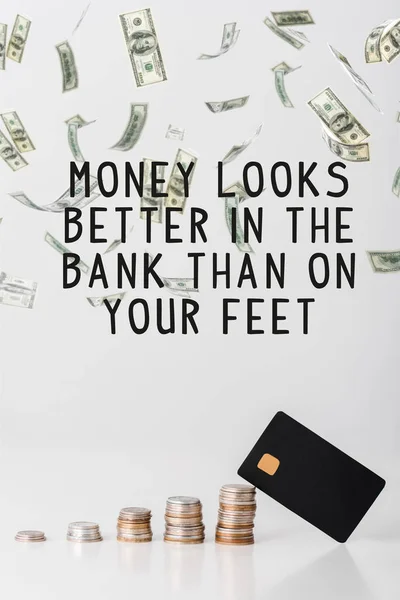 Stacks of silver and golden coins near credit card template and money looks better in the bank than on your feet letters on white — Stock Photo