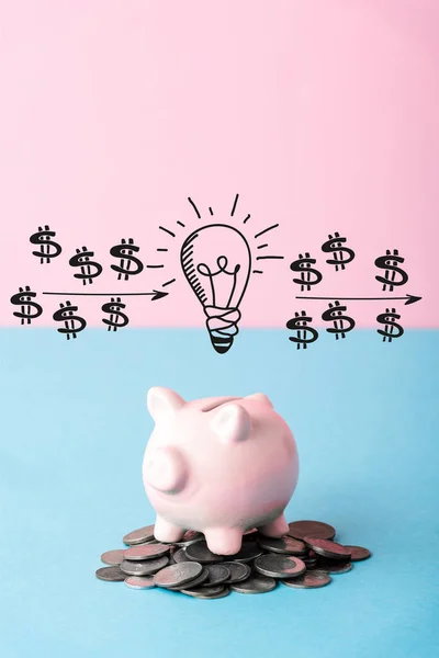 Silver coins near piggy bank and light bulb on blue and pink — Stock Photo