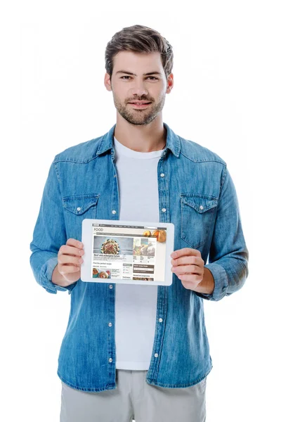 QUIIV, UCRÂNIA - AGOSTO 12, 2019: homem sorridente de camisa jeans segurando tablet digital com página de alimentos bbc isolado em branco — Fotografia de Stock