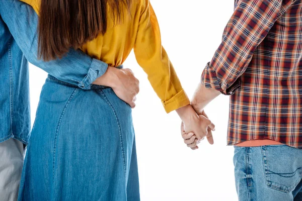 Vista ritagliata di coppia che si abbraccia mentre la donna si tiene per mano con un altro uomo isolato su bianco — Foto stock