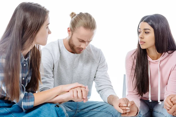 Girls in support group holding hands with sad man on chair isolated on white — Stock Photo
