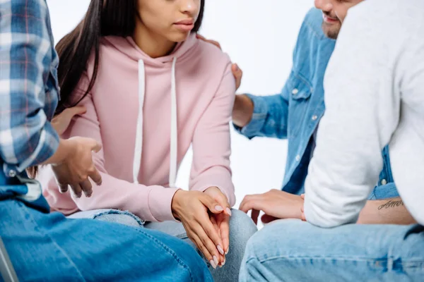 Cropped view of support group helping sad african american girl isolated on white — Stock Photo