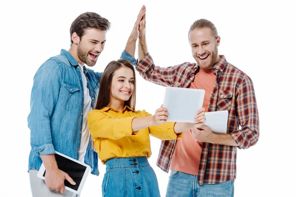 Smiling three young friends giving high five and taking selfie on digital tablet isolated on white — Stock Photo