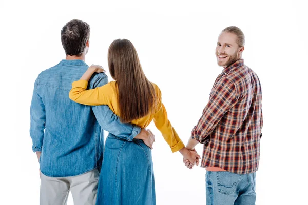 Vue arrière de couple étreignant tandis que la femme tenant la main avec un autre homme isolé sur blanc — Photo de stock