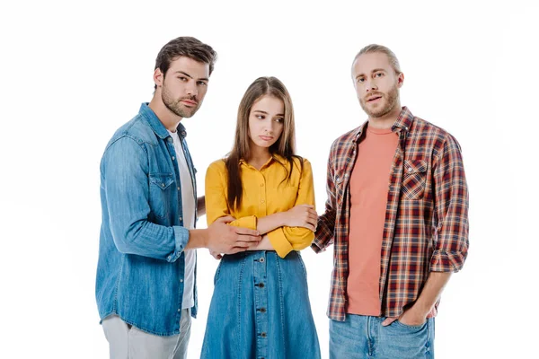 Offended girl standing near friends isolated on white — Stock Photo