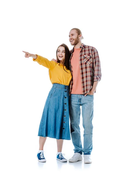 Young girl pointing with finger away near boyfriend isolated on white — Stock Photo