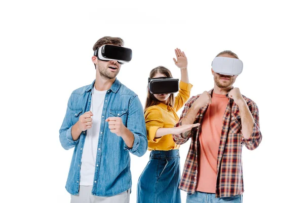 Three young friends in vr headsets imitating fight isolated on white — Stock Photo