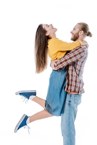 Side view of happy young man holding girlfriend isolated on white — Stock Photo