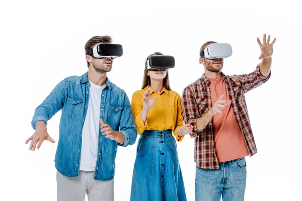 Three young friends in vr headsets gesturing isolated on white — Stock Photo