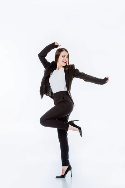 Full length view of happy businesswoman in suit posing isolated on white — Stock Photo