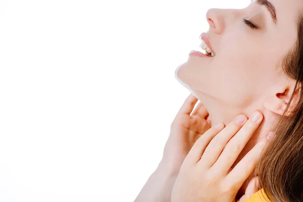 Joyful attractive girl with closed eyes touching neck isolated on white — Stock Photo