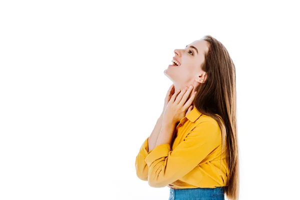 Side view of happy attractive girl touching neck isolated on white — Stock Photo