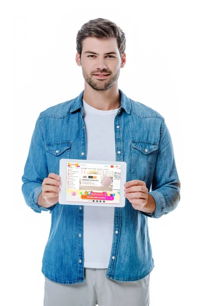 KYIV, UKRAINE - AUGUST 12, 2019: smiling man in denim shirt holding digital tablet with aliexpress page isolated on white — Stock Photo