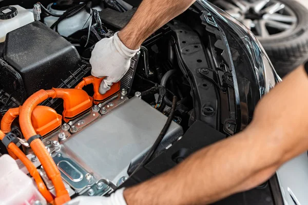 Cropped view of mechanic inspecting car engine compartment — Stock Photo