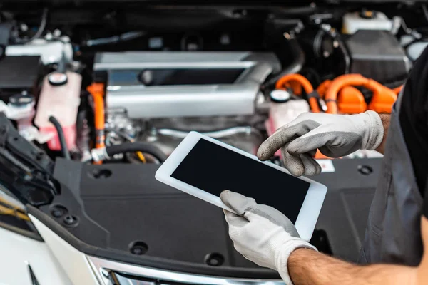 Cropped view of mechanic using digital tablet near car engine compartment — Stock Photo