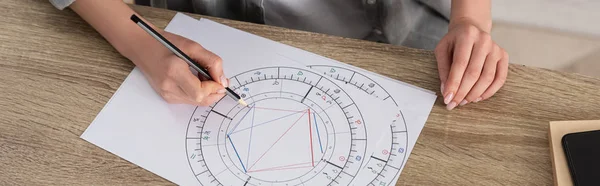 Cropped view of woman drawing natal chart at table, panoramic shot — Stock Photo