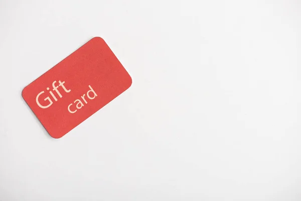 Top view of gift card on white surface with copy space — Stock Photo