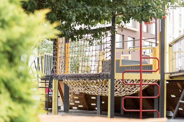 Selective focus of playground and building on street — Stock Photo