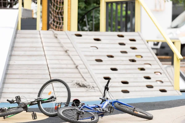 Selective focus of bikes near playground on street — Stock Photo