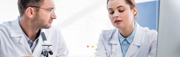 Panoramic shot of molecular nutritionists talking in lab — Stock Photo