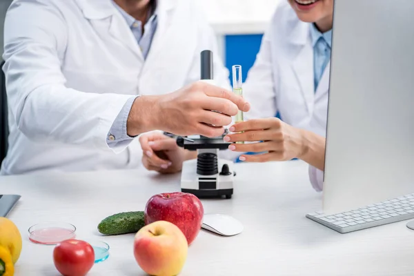 Cropped view of molecular nutritionists holding test tube in lab — Stock Photo