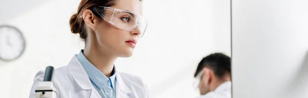 Panoramic shot of molecular nutritionists using computer in lab — Stock Photo