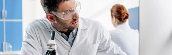 Panoramic shot of molecular nutritionist using computer in lab — Stock Photo