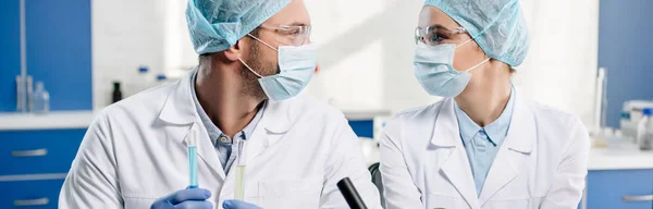 Panoramic shot of molecular nutritionists looking at each other — Stock Photo