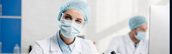 Panoramic shot of genetic consultant looking at camera in lab — Stock Photo