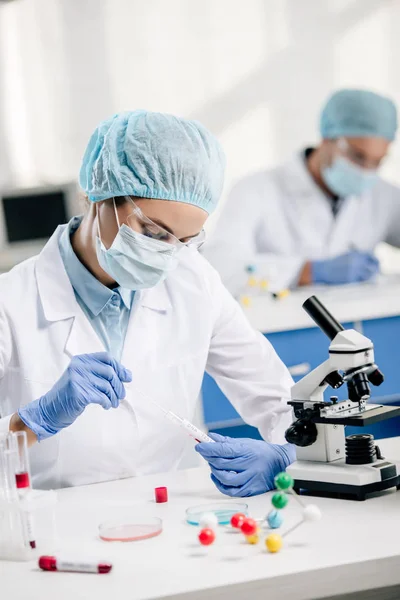 Selective focus of genetic consultant doing dna test in lab — Stock Photo