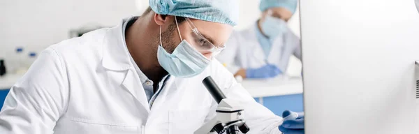 Panoramic shot of genetic consultant doing dna test in lab — Stock Photo