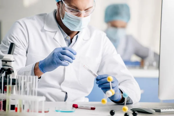 Selective focus of genetic consultant doing dna test in lab — Stock Photo