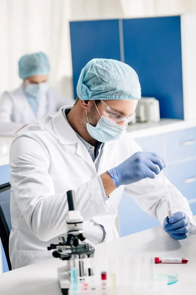 Selective focus of genetic consultant doing dna test in lab — Stock Photo