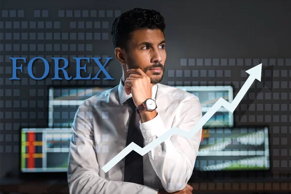 Pensive bi-racial trader looking away near forex letters in office — Stock Photo