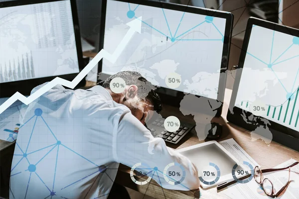 Tired bi-racial trader sleeping near computers with graphs — Stock Photo